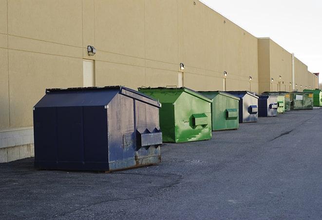 a group of dumpsters lined up along the street ready for use in a large-scale construction project in Corinne